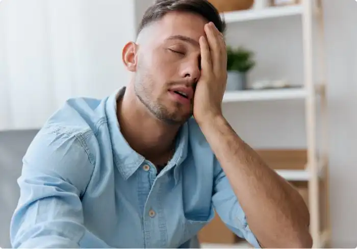 The Natural Way to Fight Fatigue and Aging: How NAD+ Therapy Works Tired man holding his head